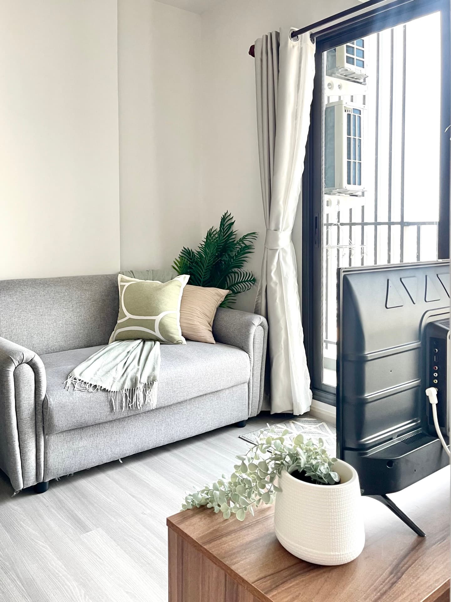 Bright living space with a grey sofa
