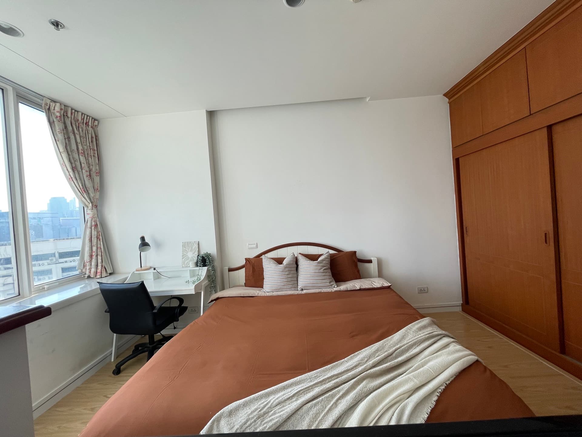 Bedroom with warm terracotta bedding